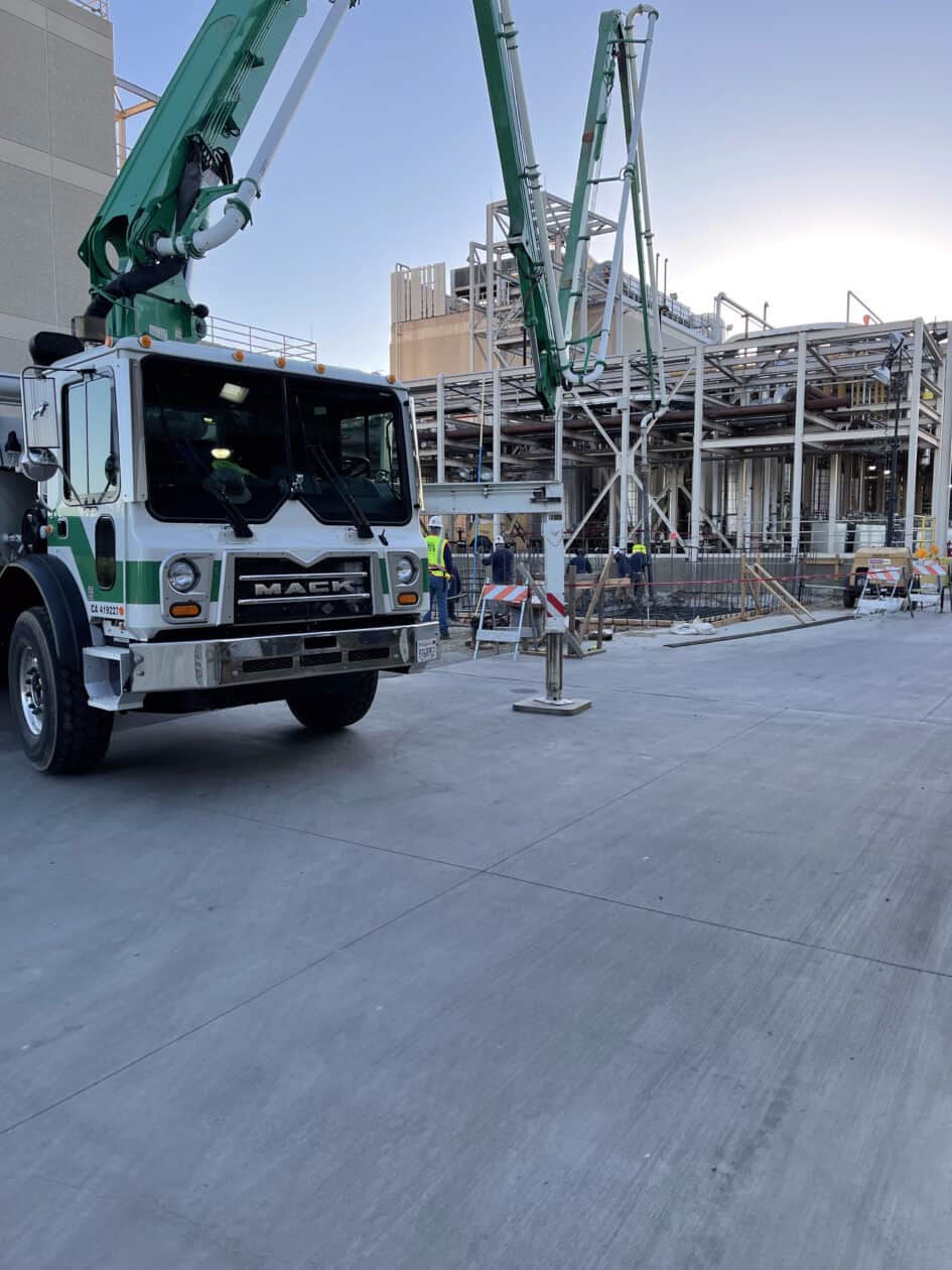 Pump truck supplying concrete to industrial foundation pad