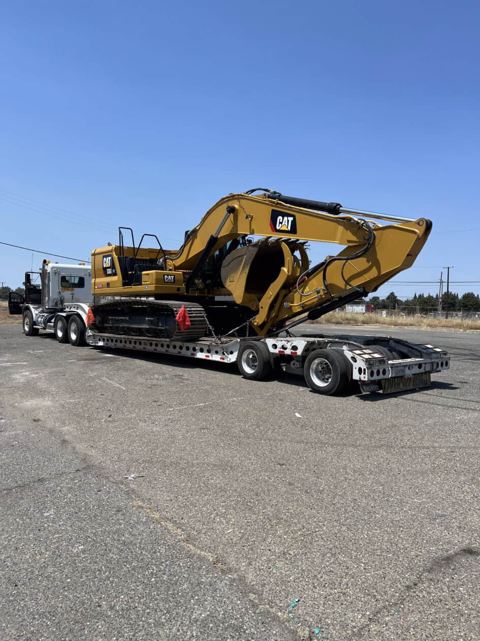 CAT 335 Excavator on a semi truck with low boy trailer